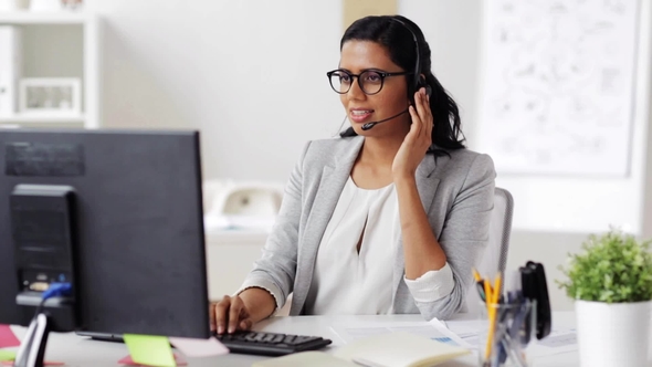 Businesswoman with Headset and Computer at Office alt