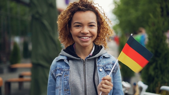 Portrait of Happy African American Woman Smiling, Holding German Flag ...