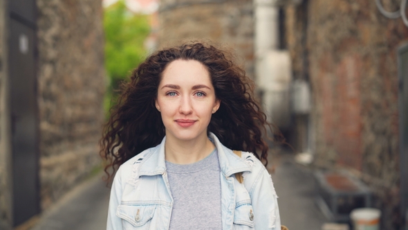 Portrait of Young Lady Happy Tourist Standing in the Street Against Buildings in Beautiful Town and alt