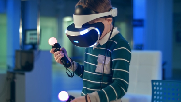 Little Boy in Virtual Reality Headset Holding Move Motion Controllers alt