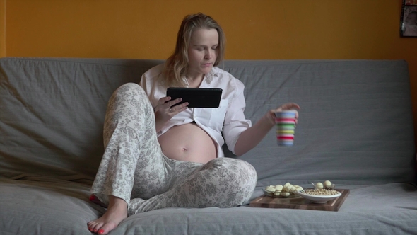 Pregnant Woman Chilling on a Sofa alt