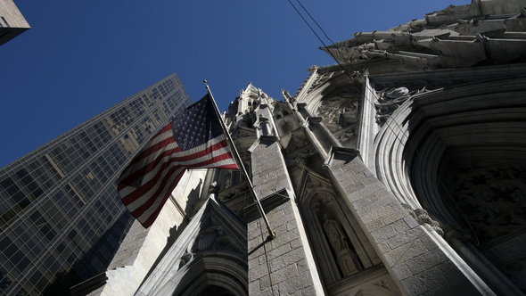 Low angle american flag fluttering at Saint Patrick Church in New York