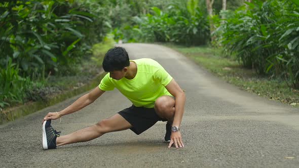 Man Runner Stretching Legs Before Run alt