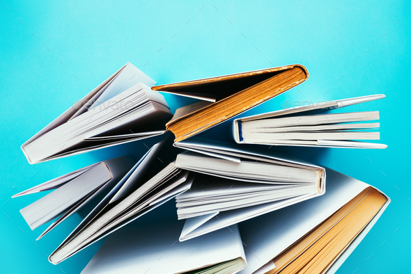 Books from above on blue background Stock Photo by stevanovicigor | PhotoDune