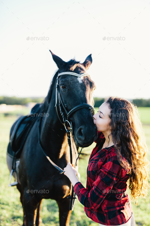 Black horse kissed by a young woman. Stock Photo by photocreo | PhotoDune