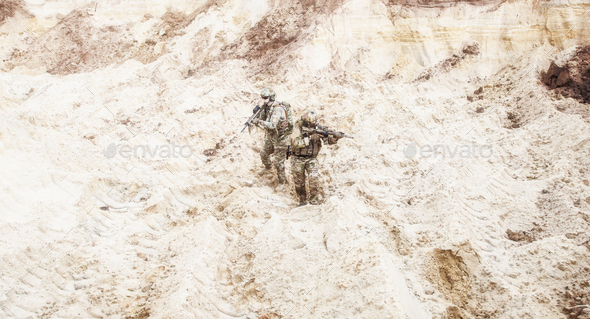 Infantrymen ready for fight moving in desert - Stock Photo - Images