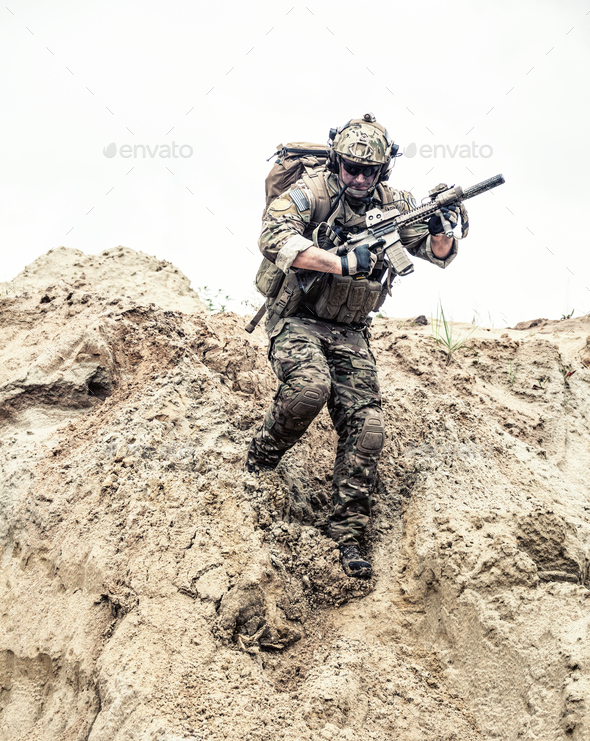 Army ranger with arms running down from sand dune Stock Photo by Getmilitaryphotos
