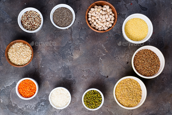 Superfoods and cereals selection in bowls on grey concrete background - Stock Photo - Images