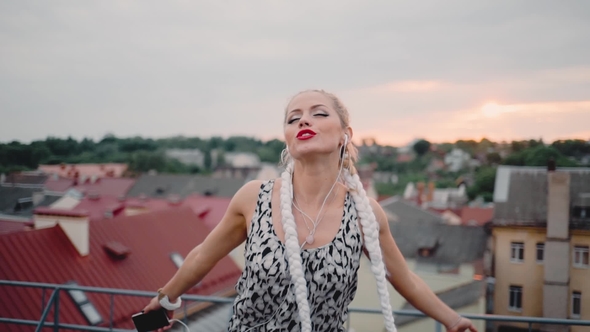 Happy Girl Listening Music with Headphones and Dancing alt