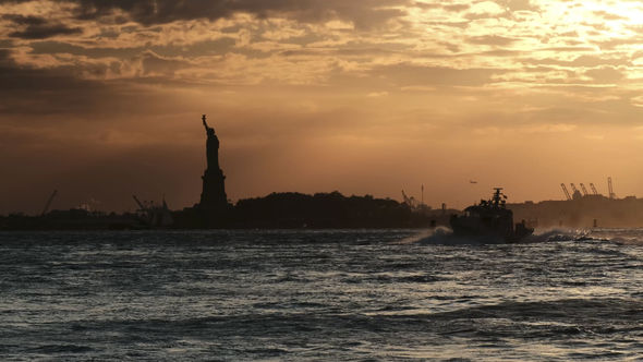 Sunset at the Hudson River with the silhouette statue of Liberty