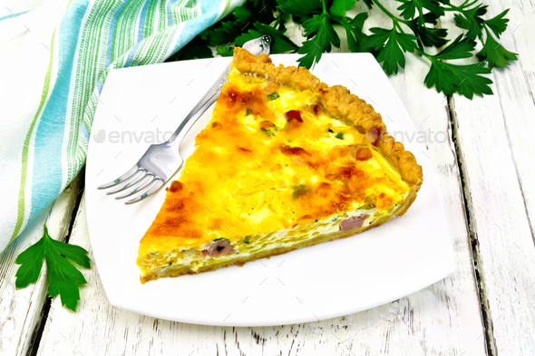 Quiche with pumpkin and bacon in white plate on table - Stock Photo - Images