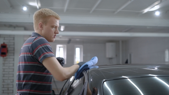 Master of Auto-service Is Wiping Roof of Car By Wipes After Processing in a Working Room, Polishing alt