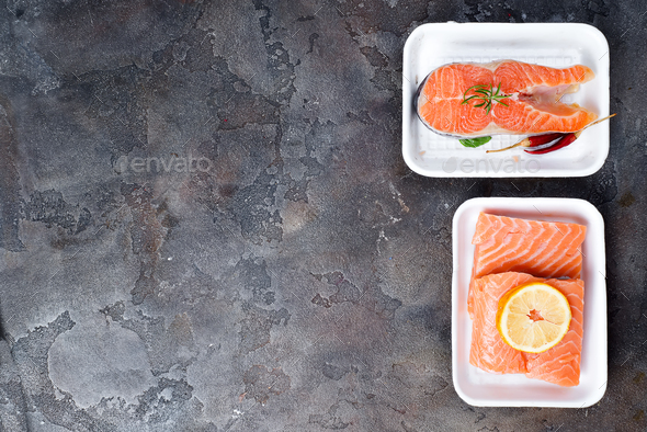 two fresh raw salmon steaks are laying on white food tray made from polystyrene foam - Stock Photo - Images