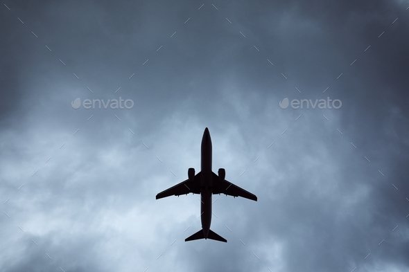 Silhouette of airplane in storm