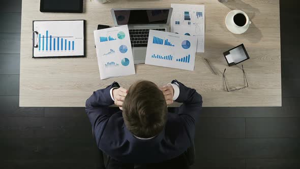 Office Manager Sitting at Desk and Grabbing His Head in Despair, Hopelessness alt