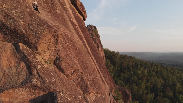 Aerial View of the People Climb To the Top of the Rock in the Siberian Nature Reserve Stolby alt
