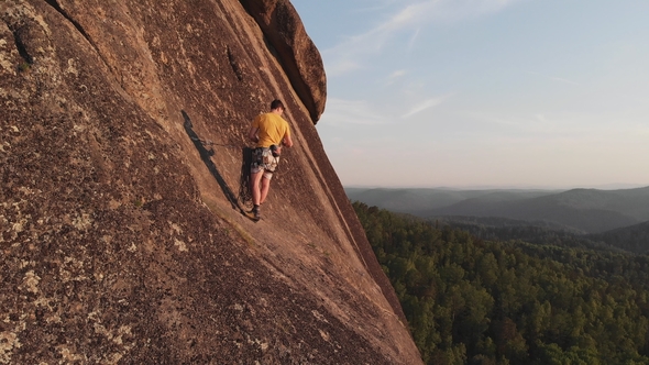 Aerial View of the People Climb To the Top of the Rock in the Siberian Nature Reserve Stolby. alt