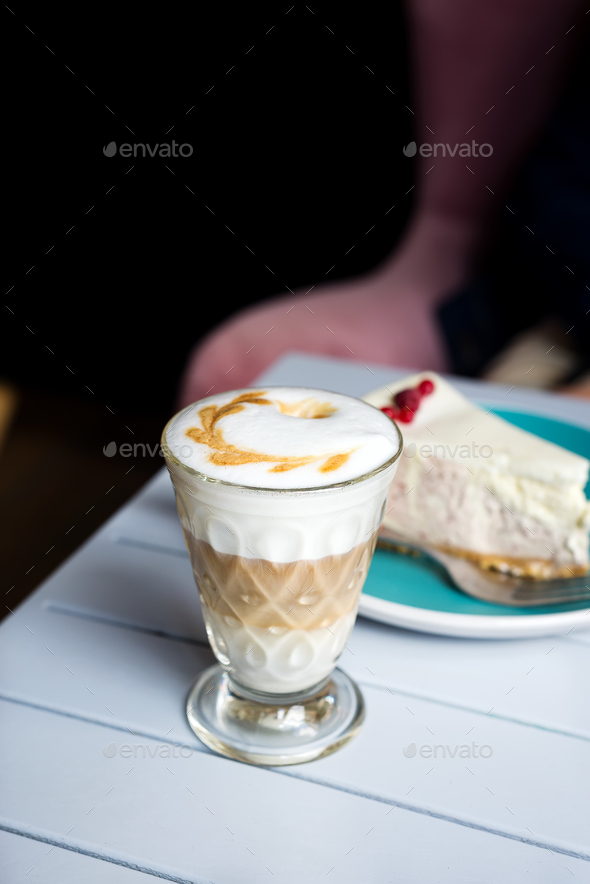 Glass of Latte macchiato with rich milk foam in cafe Stock Photo by