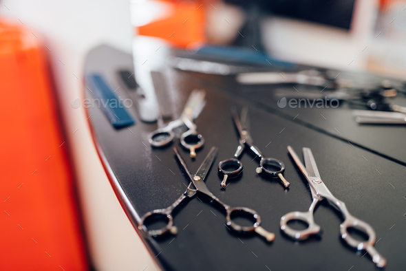 Scissors on wooden table in hairdressing salon Stock Photo by NomadSoul1