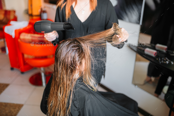 Hairdresser drying hair, female hairdressing Stock Photo by NomadSoul1