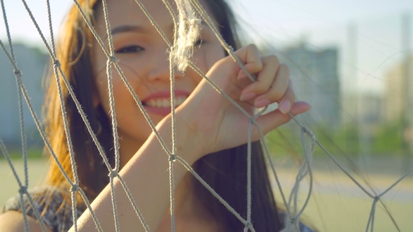 Asian Girl with Beautiful Smile and Long Hair Posing in Front of Camera