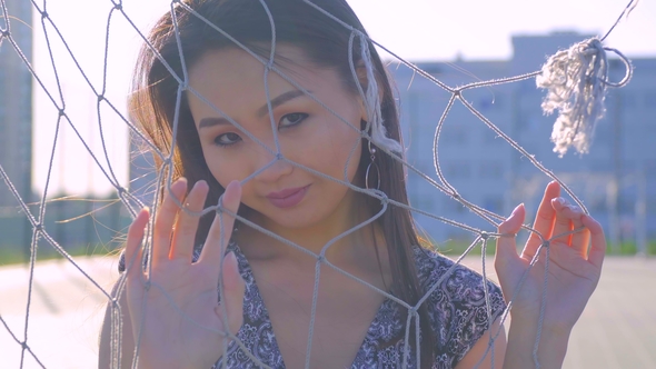 Asian Girl with Beautiful Smile and Long Hair Posing in Front of Camera