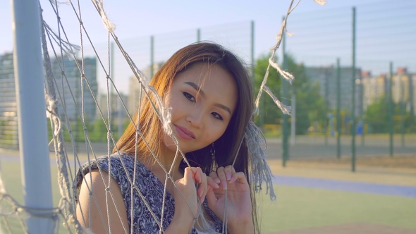 Asian Girl with Beautiful Smile and Long Hair Posing in Front of Camera