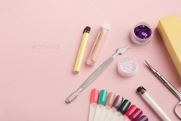 Manicure supplies on pink background