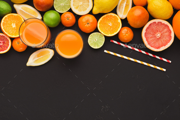 Variety of ripe citruses on black background Stock Photo by Prostock-studio