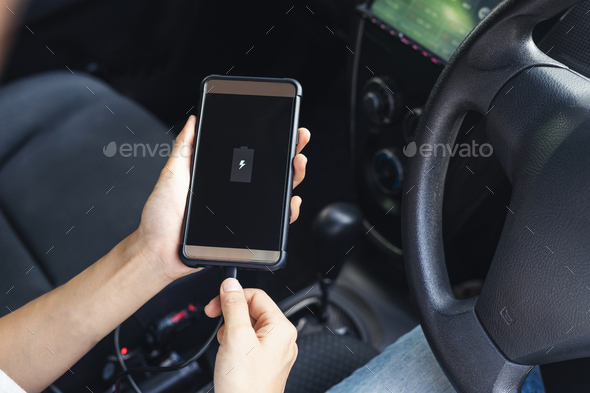 Hand holding smartphone and changing phone battery in car Stock Photo by kitzstocker