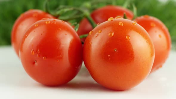 Ripe natural tomatoes close-up. Organic tomato rotating on a green background Macro shot. alt