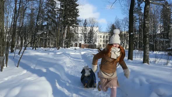 Child Teenage Sledding, Red-Haired Kid Walking at Sunny Winter Day