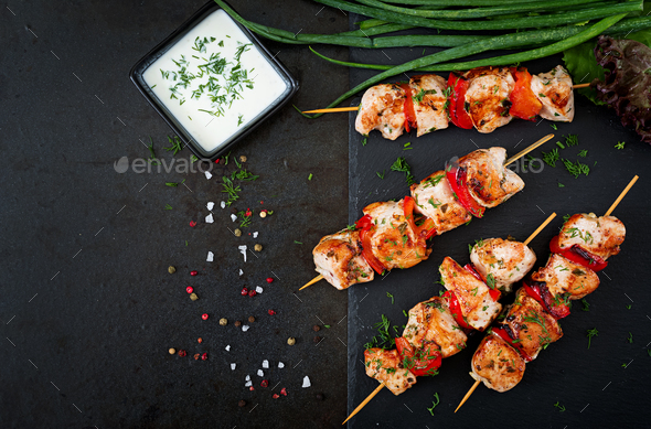 Chicken skewers with slices of sweet peppers and dill. Tasty food. Weekend meal. Top view. Flat lay. Stock Photo by Timolina