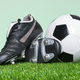 Football or Soccer boots and ball on grass - PhotoDune Item for Sale