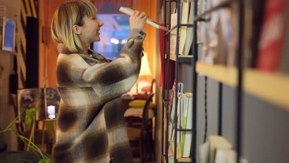 Woman Reading Book in Library alt