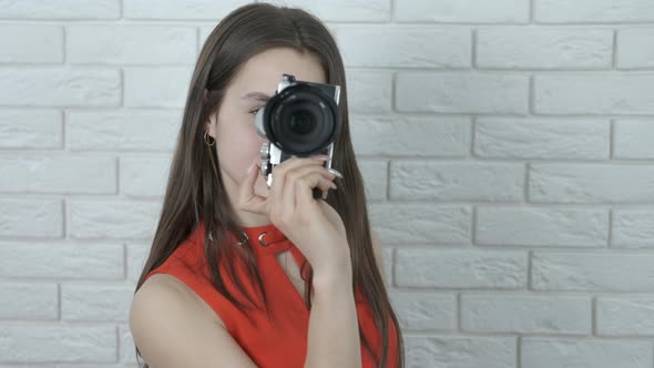 Young photographer takes a photo.  alt