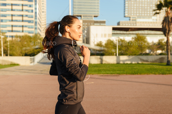 Amazing beautiful young asian sports woman running Stock Photo by vadymvdrobot