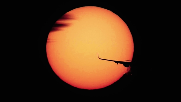 Jet Plane Landing with Sun Behind It
