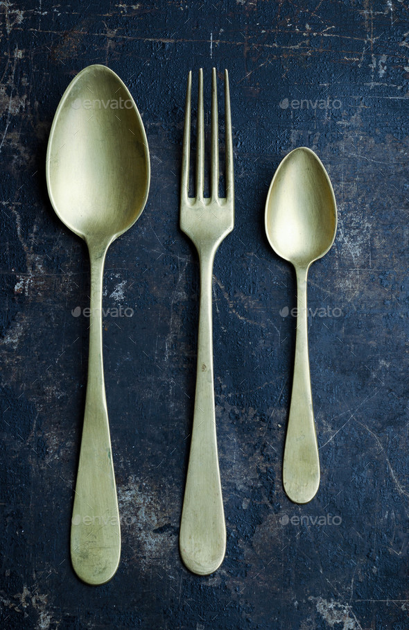 Golden spoons and fork Stock Photo by bogdandreava PhotoDune