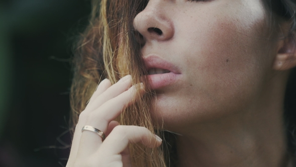 A  View of a Cropped Frame a Slow-moving Shot of a Girl's Face with a Mouth Slightly Open Wit alt