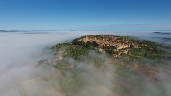 Old Italian City on Hill in Fog. Aerial Tuscany alt