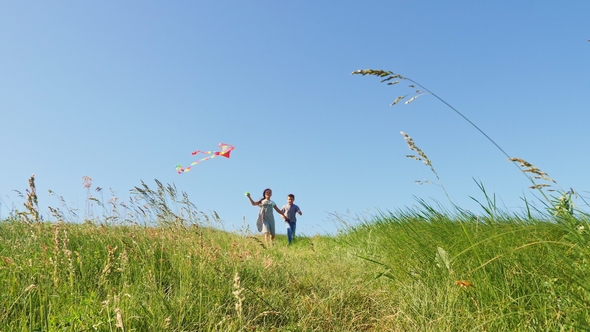 Children Run Down the Green Hill with a Flying Kite alt
