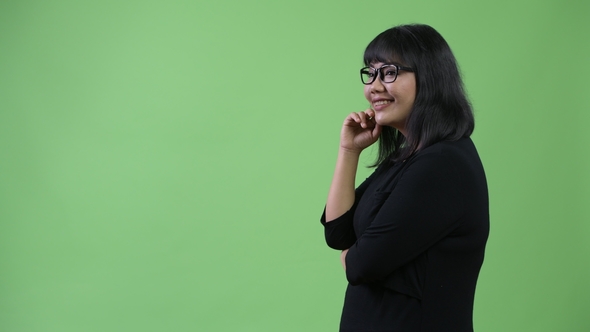 Profile View of Beautiful Happy Asian Businesswoman Thinking alt