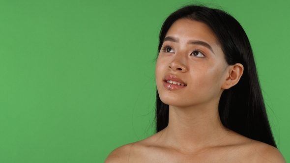 Beautiful Asian Woman Looking Away Dreamily on Chromakey Background alt