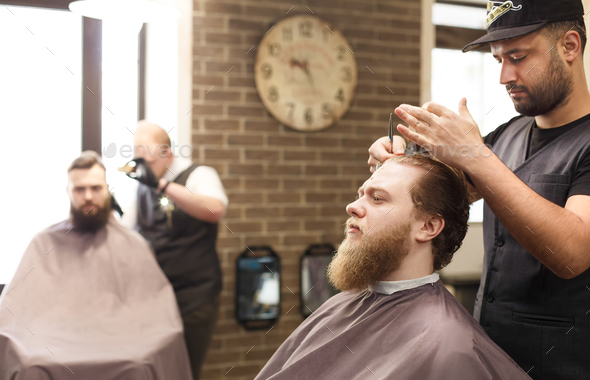 Man Getting Haircut By Hairstylist At Barbershop Stock Photo By