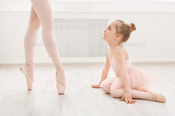 Little girl looking at professional ballet dancer Stock Photo by Prostock-studio