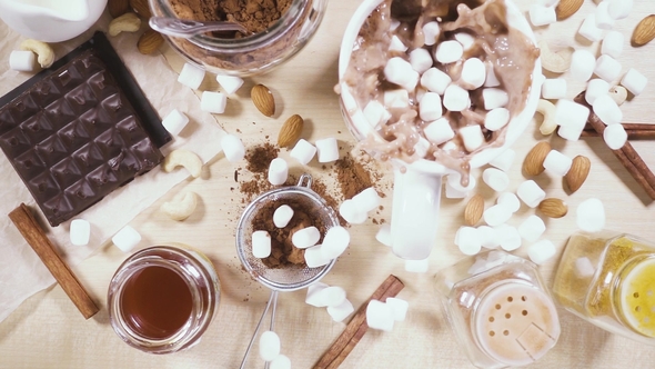 On a Wooden Table a White Mug and Ingredients for Cocoa