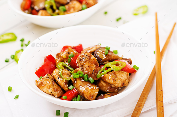 Homemade kung pao chicken with peppers and vegetables. Chinese food. Stir fry. Stock Photo by Timolina