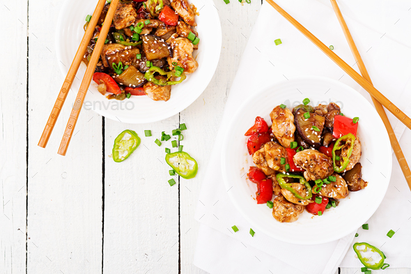 Homemade kung pao chicken with peppers and vegetables. Chinese food. Stir fry. Top view. Flat lay Stock Photo by Timolina