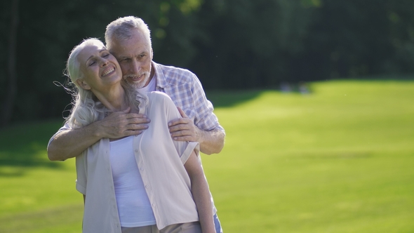 Portrait of Passionate Senior Couple on Green Lawn